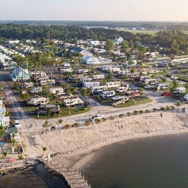 An aerial shot of an RV park near the beach.