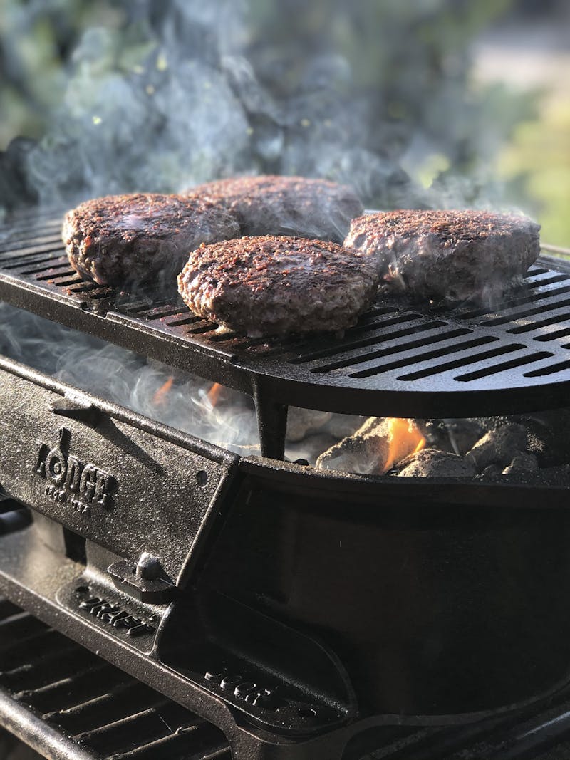 Burger grilling on a grill.