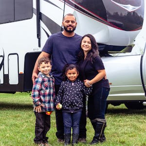 The Class Family posed outside with their toy hauler RV.