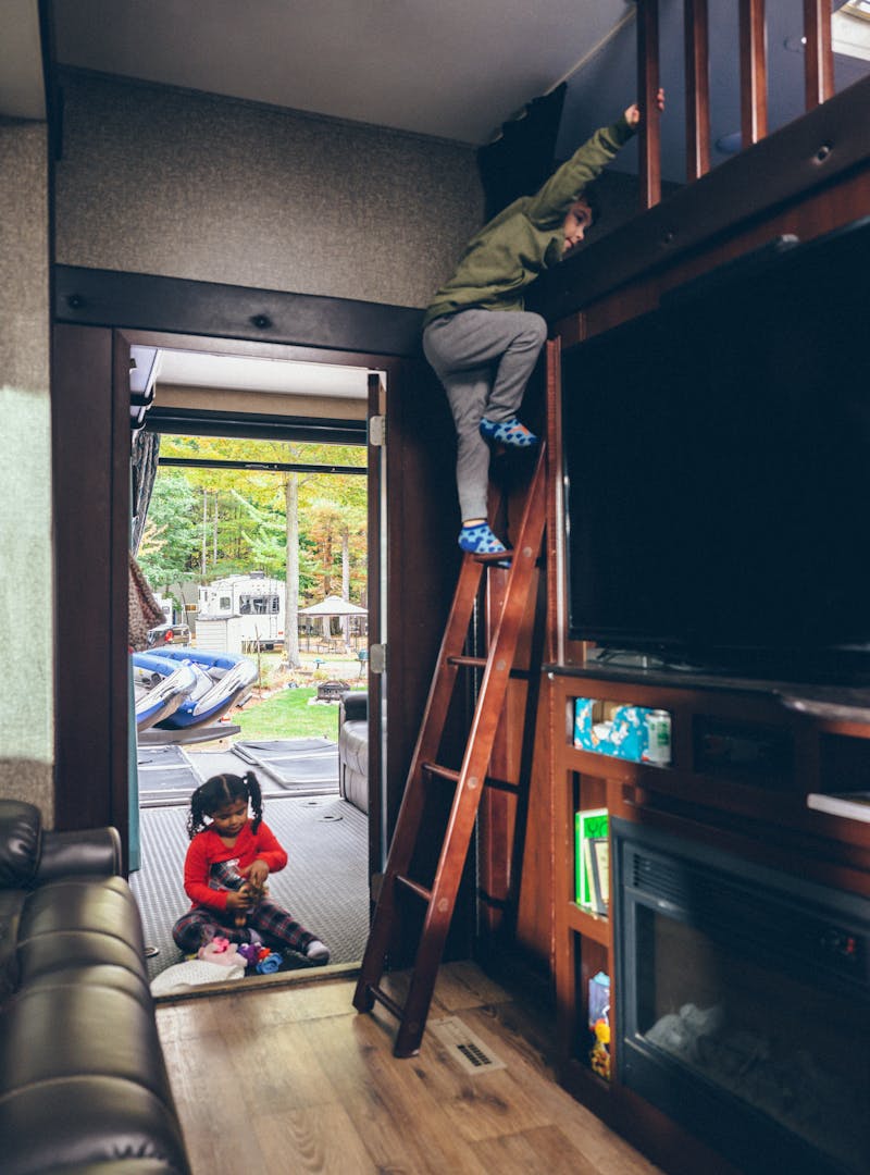Julian climbing down from a bunkbed to go play outside.