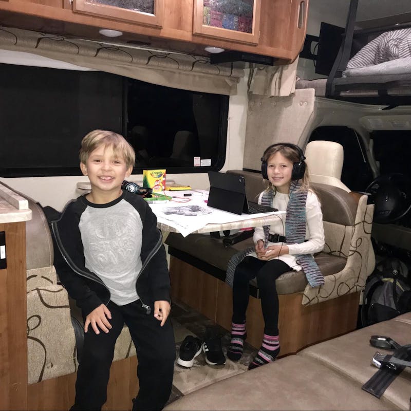 Raoul Martinez's children work and play at the dinette in a Thor Motor Coach Class C RV.