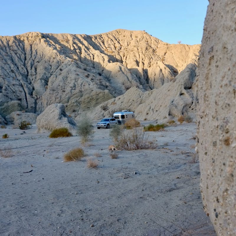 Dr. Na's RV parked in a sandy desert.