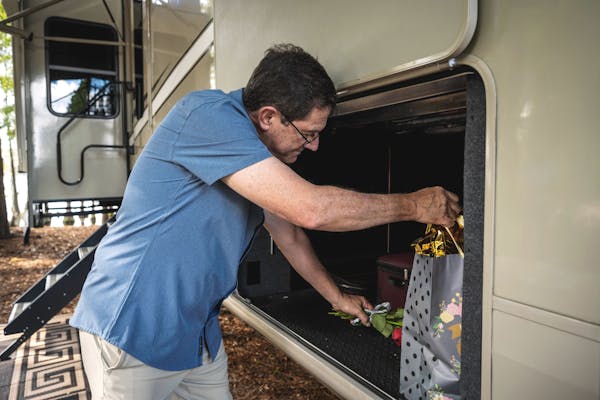 A man pulling a gift out of an RV
