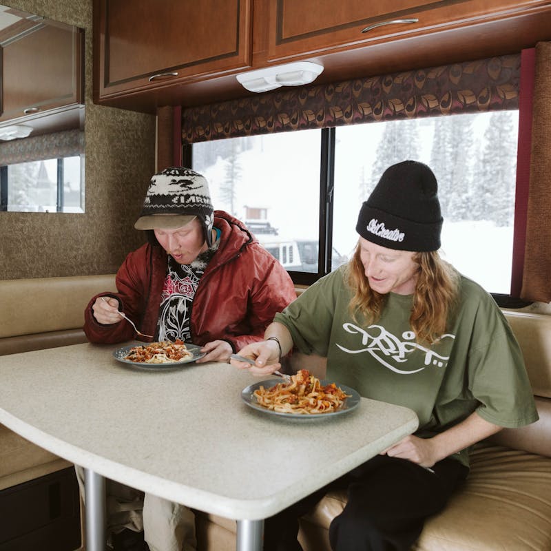 Ryan and his friend eating homemade veggie spaghetti in the RV.