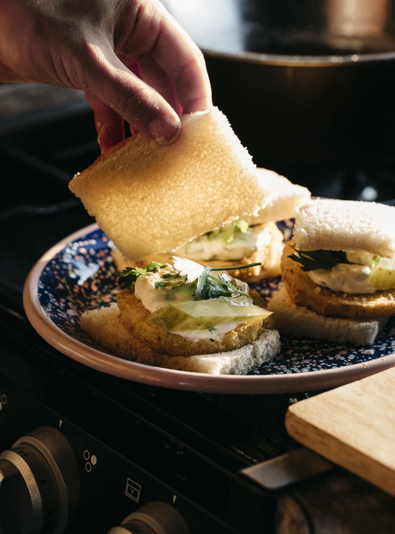 Eggplant slider being assembled on plate.