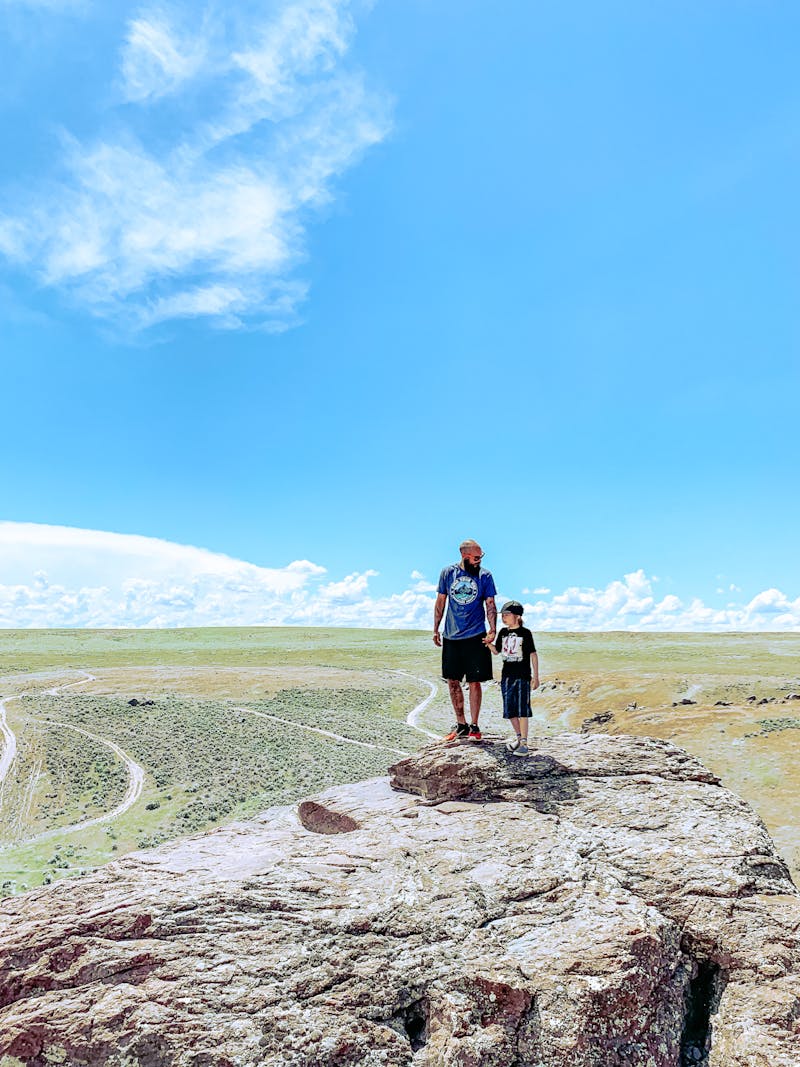 Justin Russell holds his son's hands while on a hike.