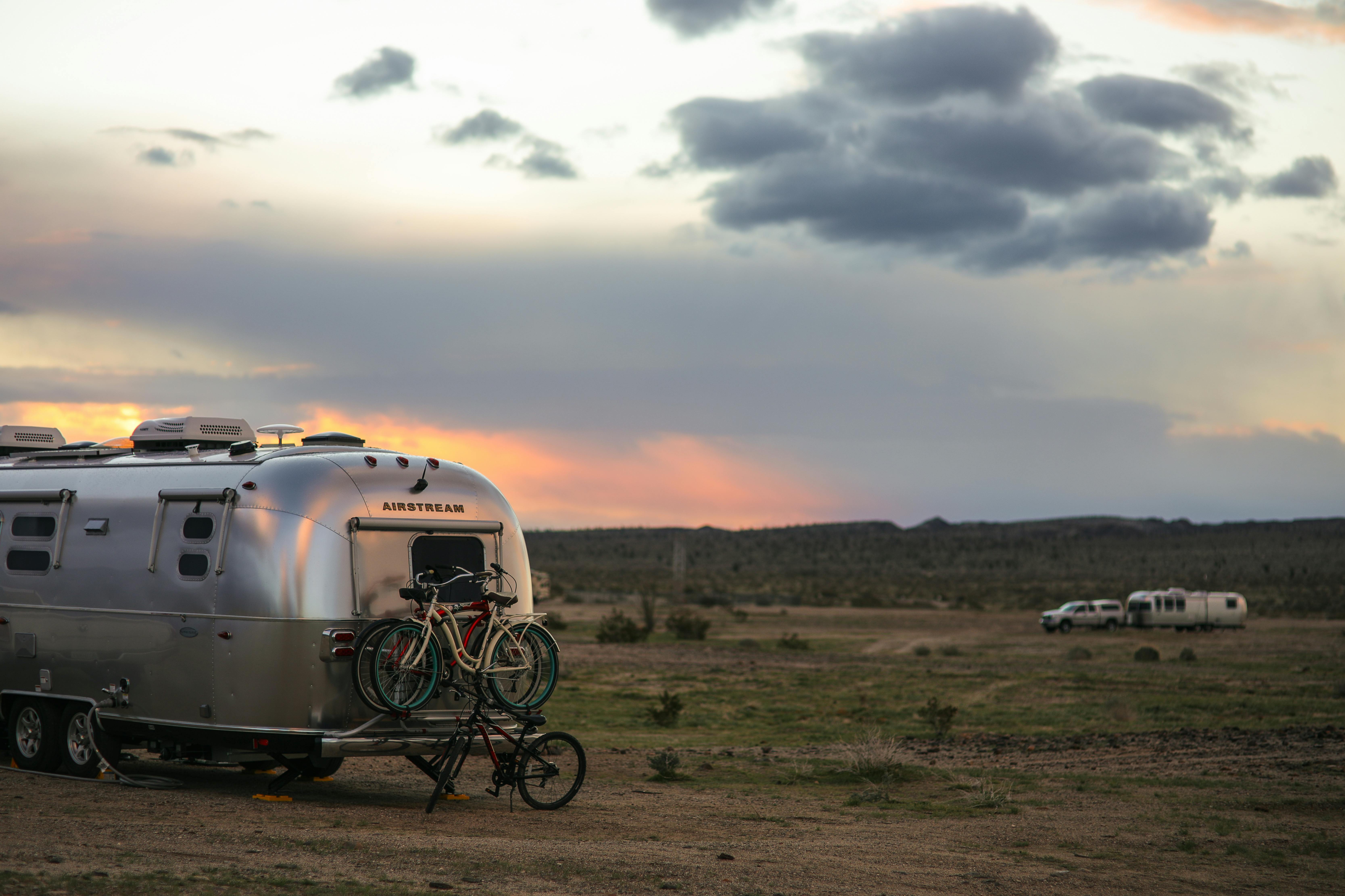Karen Blue's Airstream with bikes attached to the back and boondocking at dusk