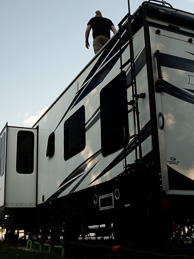 Andy Murphy on top of his stationary RV