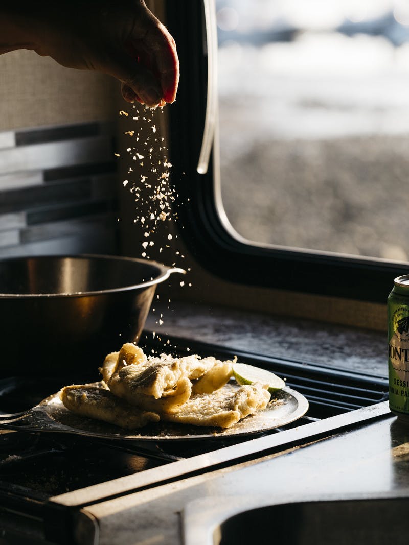 Plate of Fried White Fish with Lime Salt in kitchen RV.