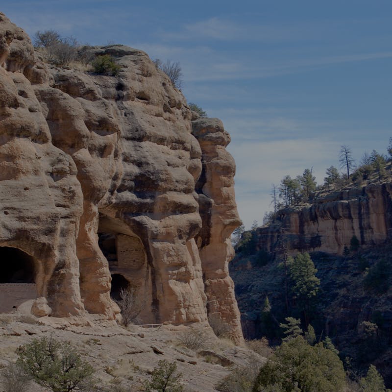 Cave cliff formations inside tan colored mountains