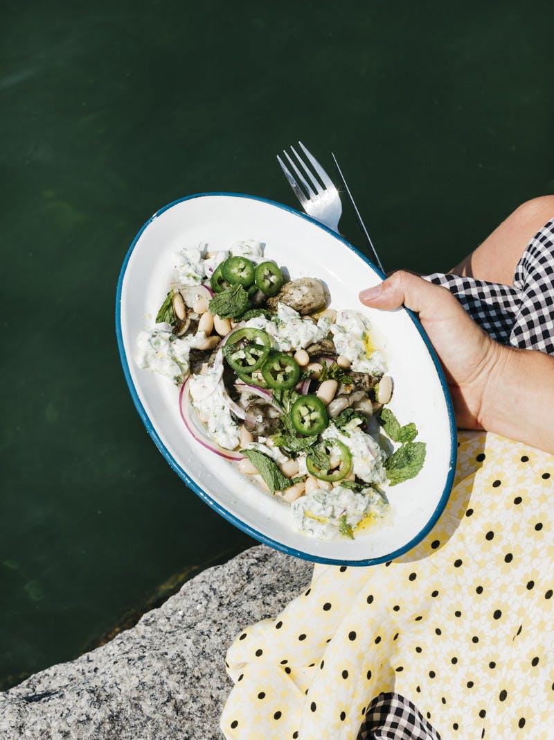 A plate of squid and bean salad with freshly cut jalapeƱo slices on top.