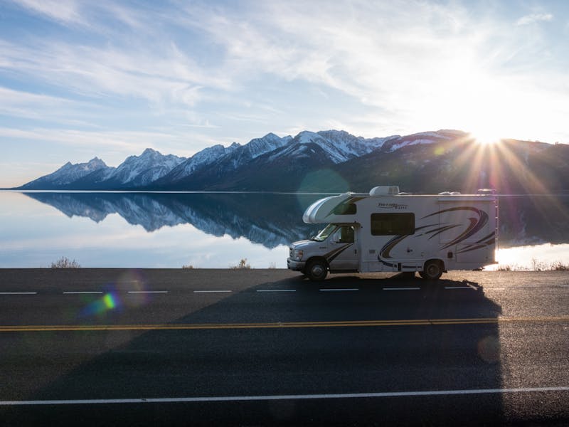 A Class C RV drives in Glacier National Park.
