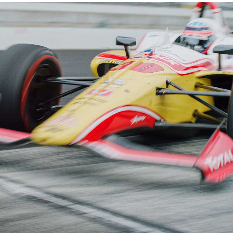 Takums Sato's race car zooms down the track at the Indy 500.