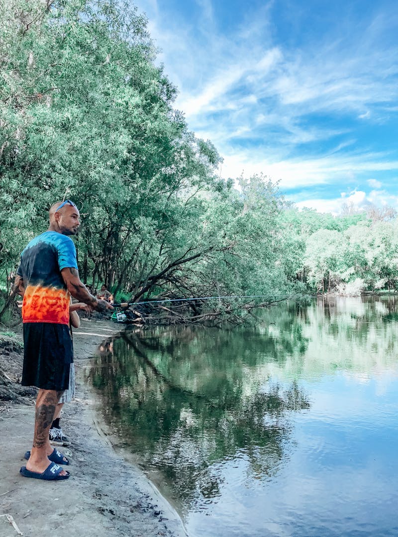 Justin Russell fishing at a pond.