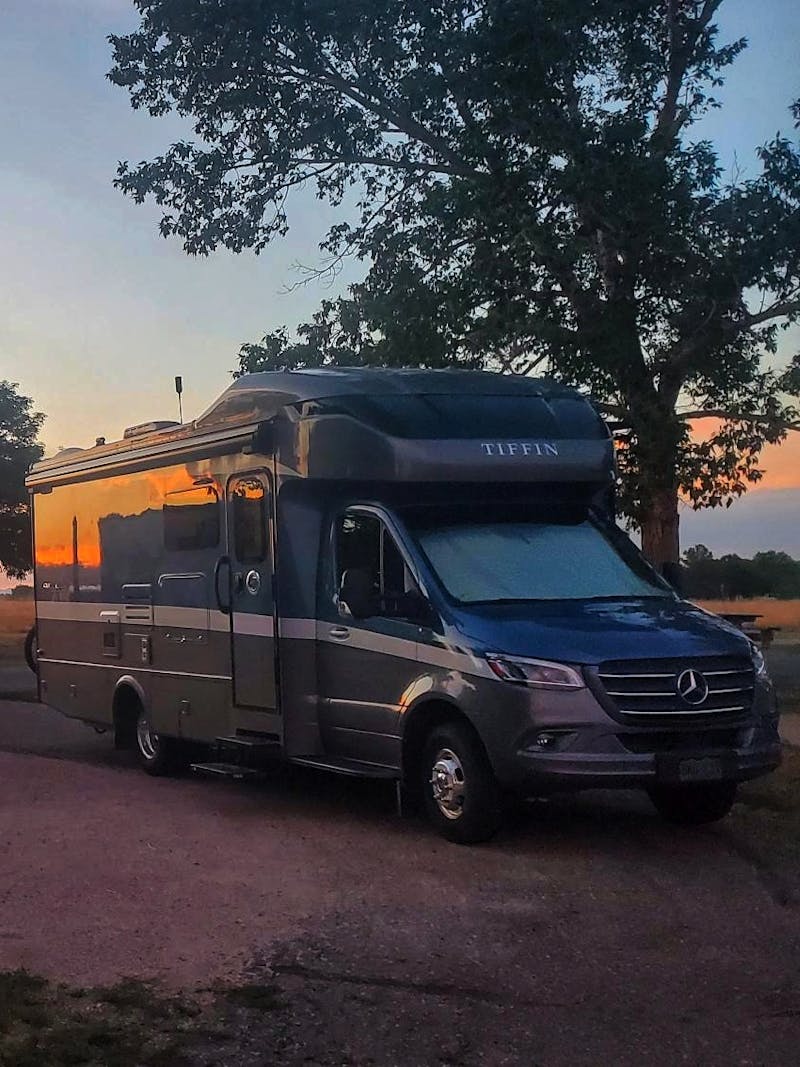 Dustin and Sarah Bauer's Tiffin Wayfarer parked at a campsite at sunset 