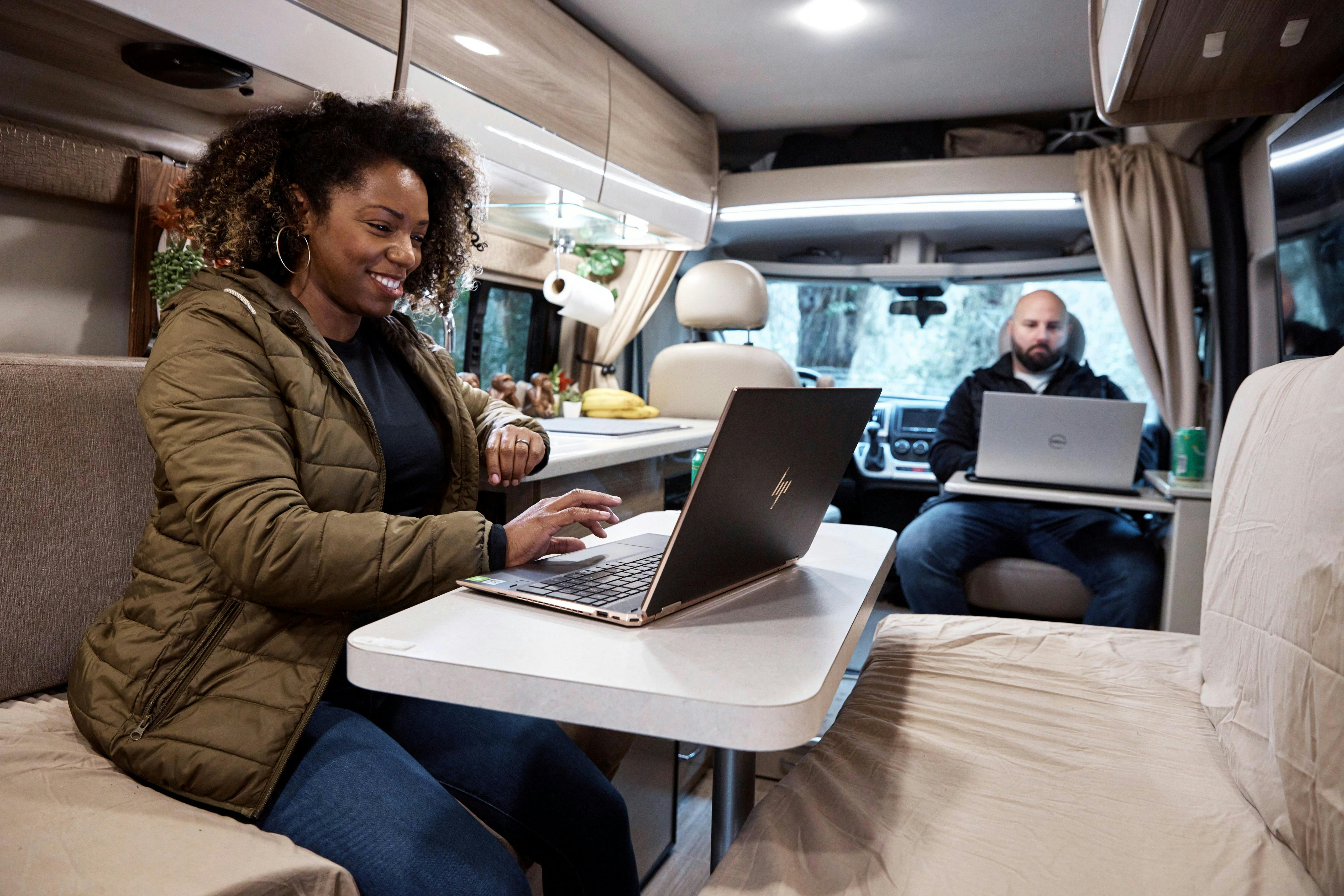 Gabe and Rocio Rivero working inside their RV on their computers