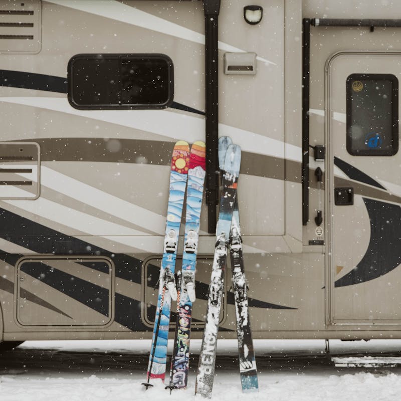Two sets of skis outside Ryan's RV.
