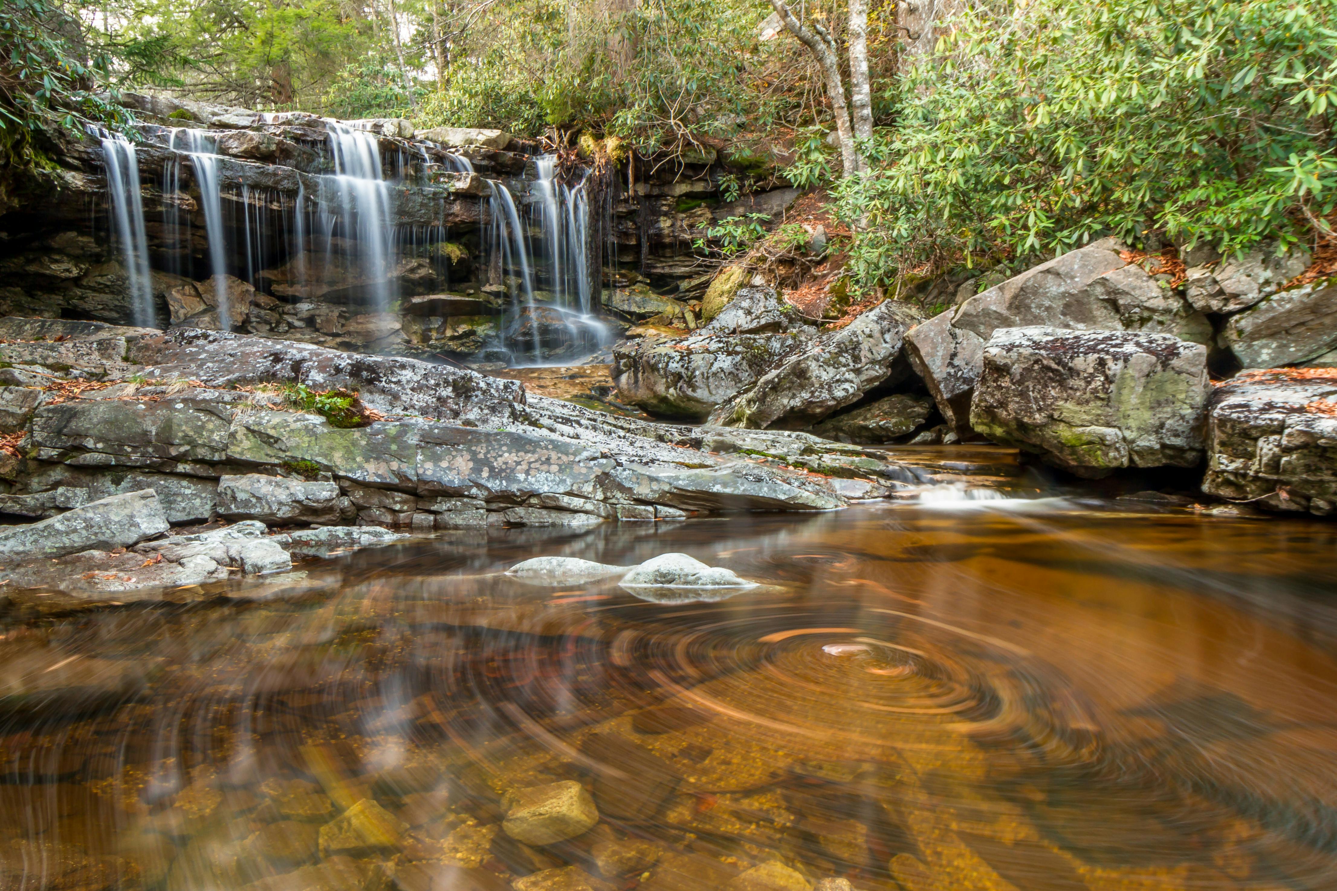 A waterfall pouring over rocks into a pool in Monongahela National Forest.