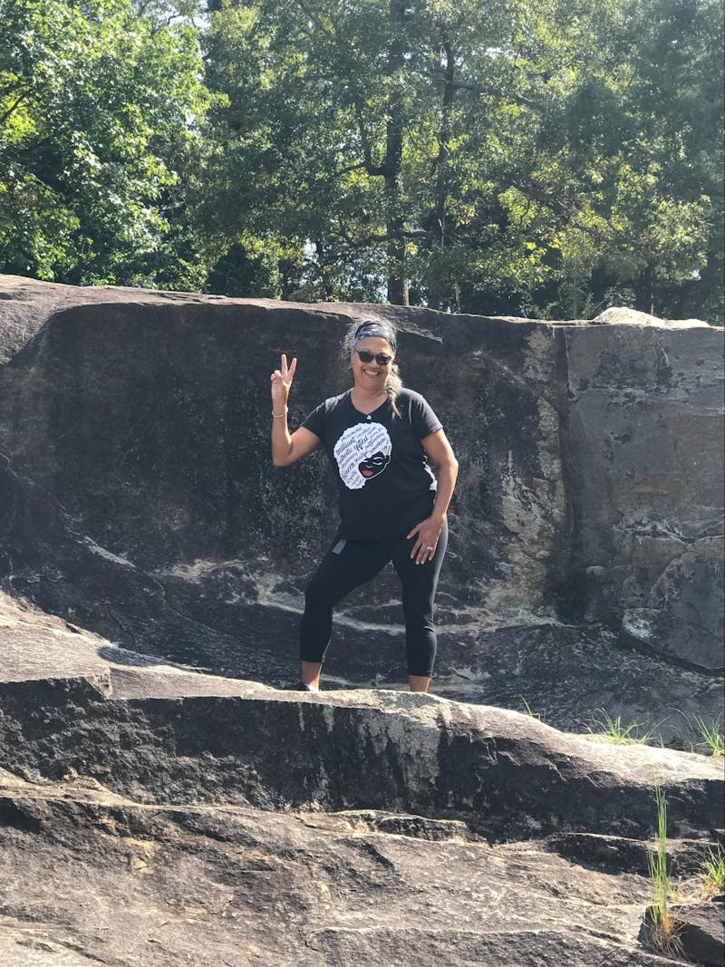 Kirsten Womack poses during a hike at Flat Rock park in Columbus, Georgia. 