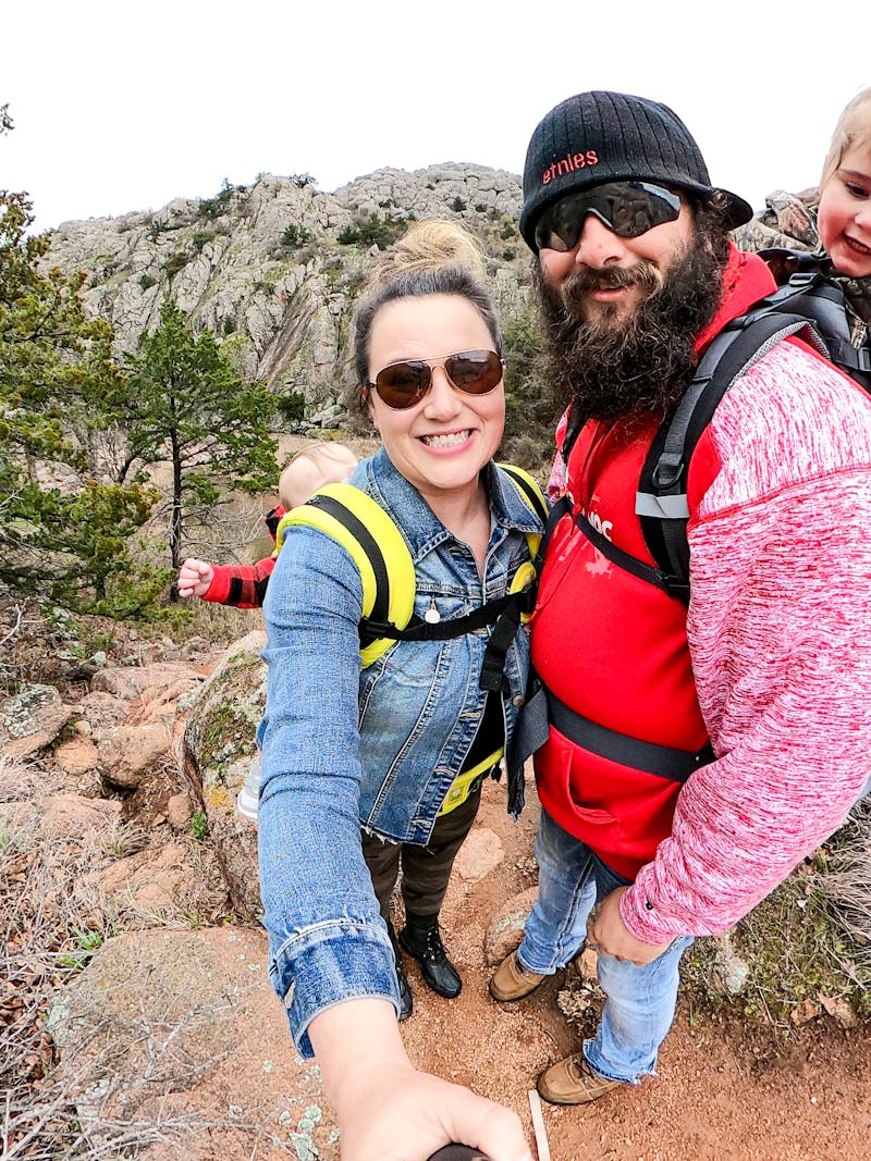 Sammy Seles takes a selfie photo of her husband and two small children on a hike.