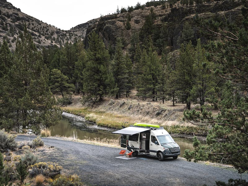 A Jayco Terrain camper van parked next to a river