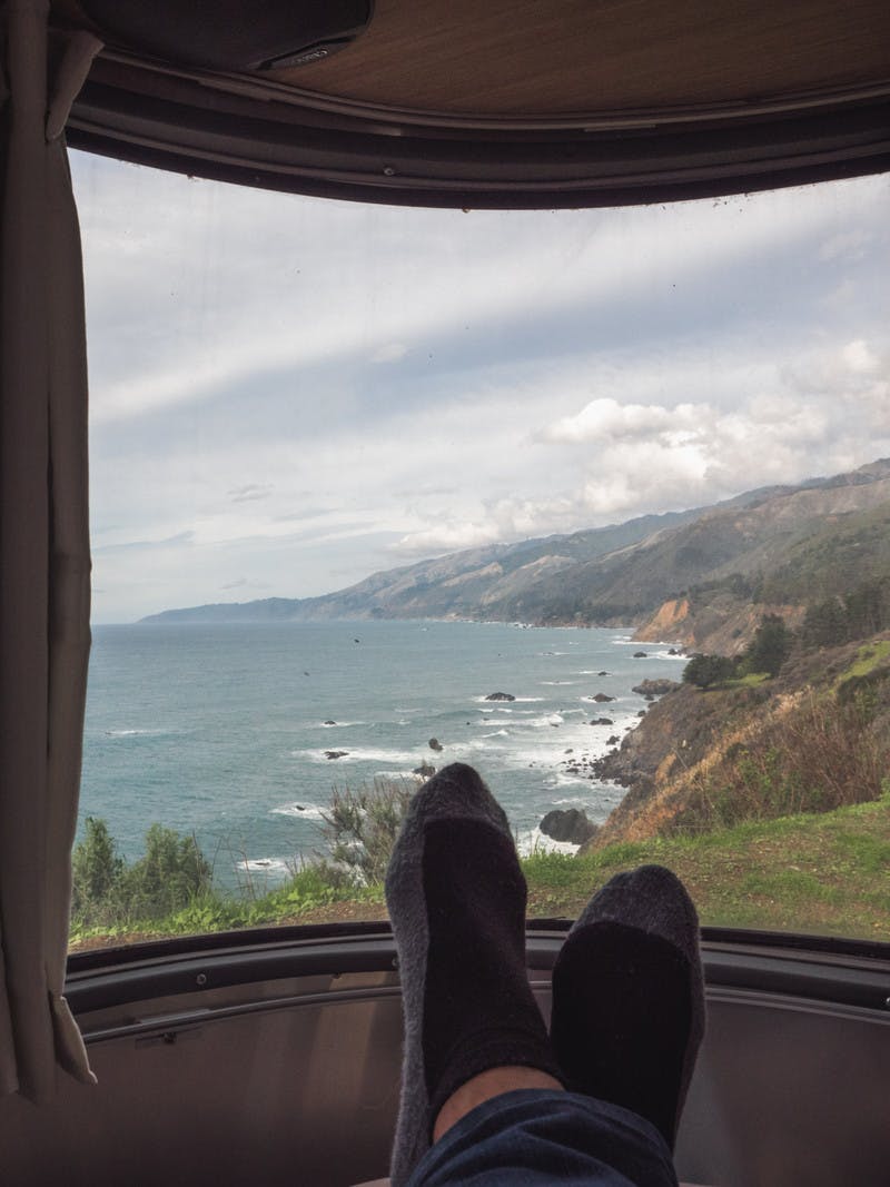 A view of the Big Sur coastline, looking out from an RV window. 