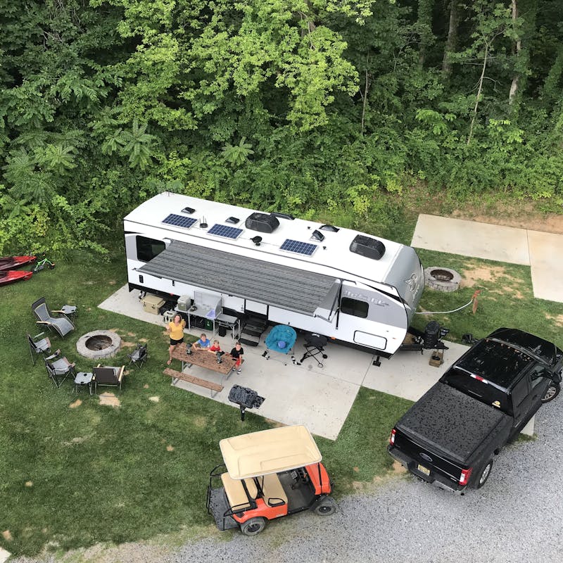 An aerial shot of an RV parked at an idyllic campground.