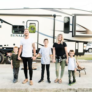 The Cutler family posed in front of their RV for a portrait.