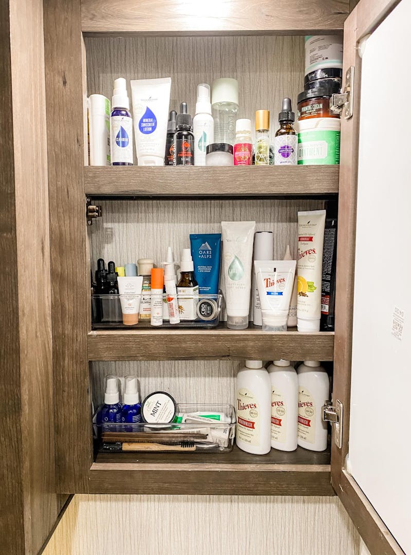 Small items organized in bins within the bathroom medicine cabinet of Brittnee Proha's Heartland Cyclone.