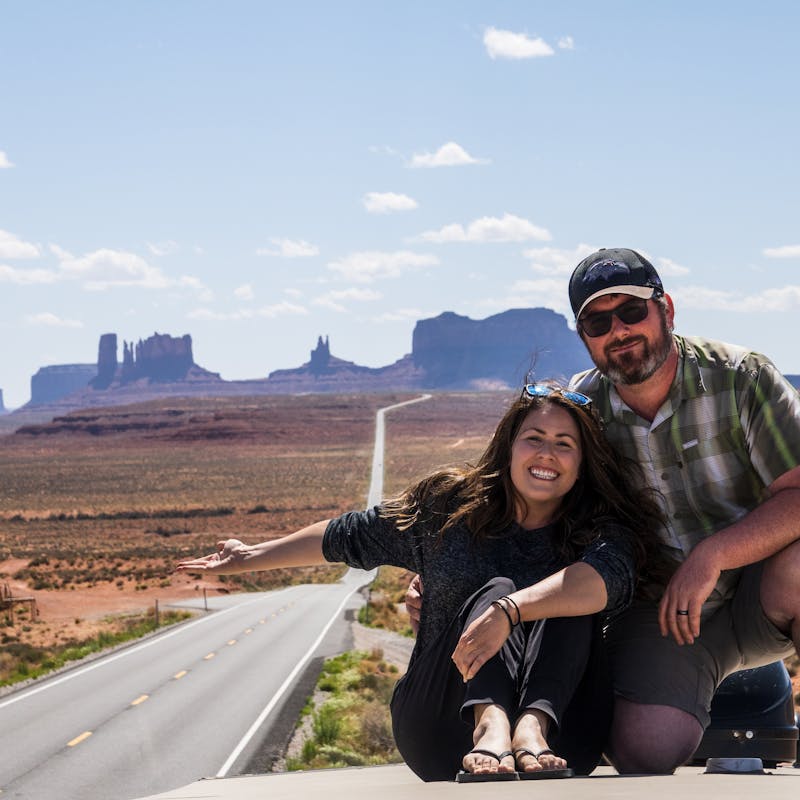 Cindy Scott and her husband sitting on top of their Keystone Cougar.