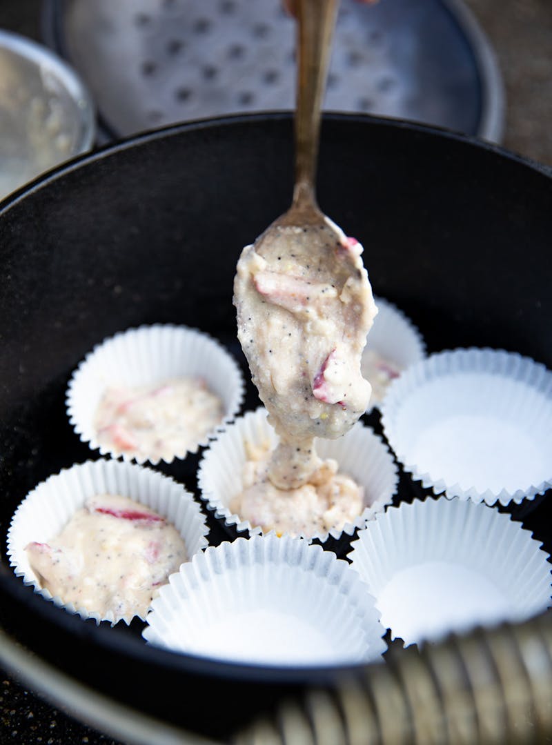 Batter for strawberry corn muffins poured into cups.