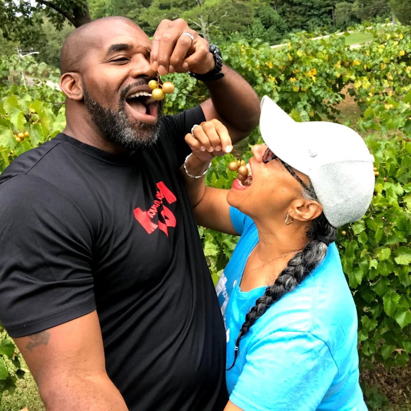 Kirsten Womack and her husband pick grapes and eat them at a park in Leesburg, Alabama.