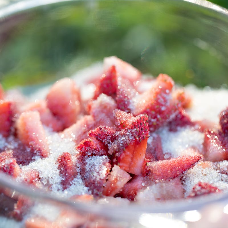 Chopped strawberries coated in sugar.