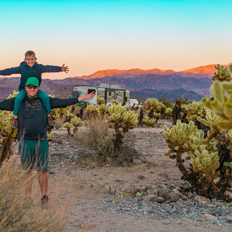 Renee Tilby's husband and her son taking a photo in the desert