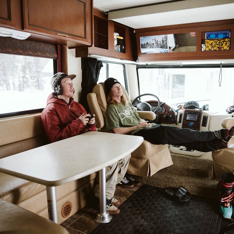 Ryan and a friend kicking back inside his RV after a long day.