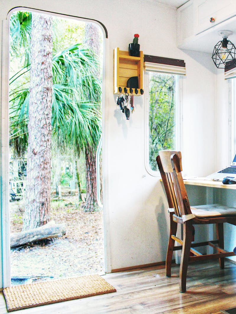 A view inside and outside an RV parked at a tropical state park in Florida.