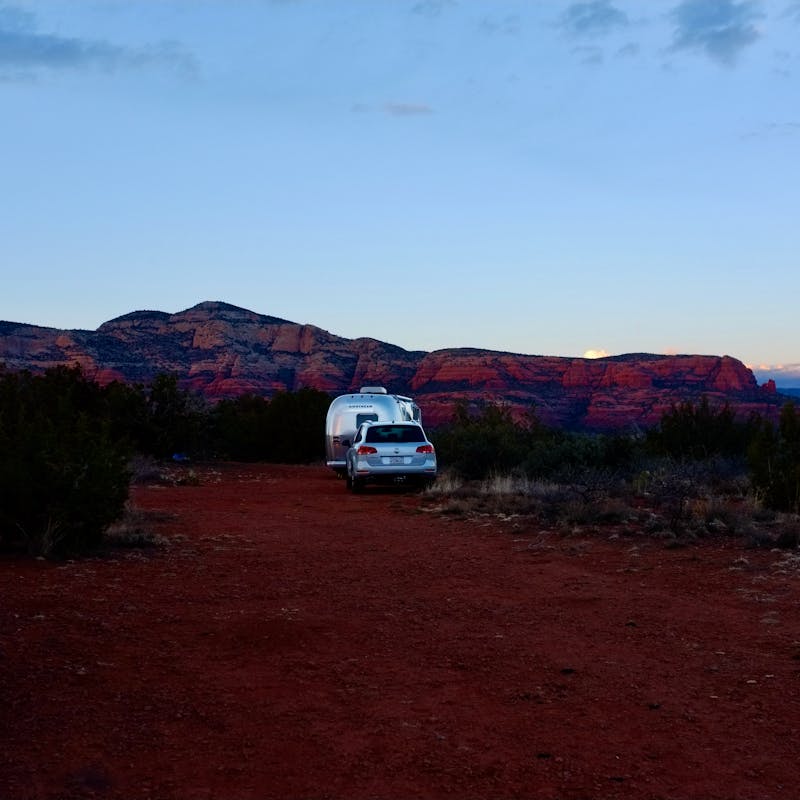 Dr. Na's RV parked at dusk in a desert landscape.