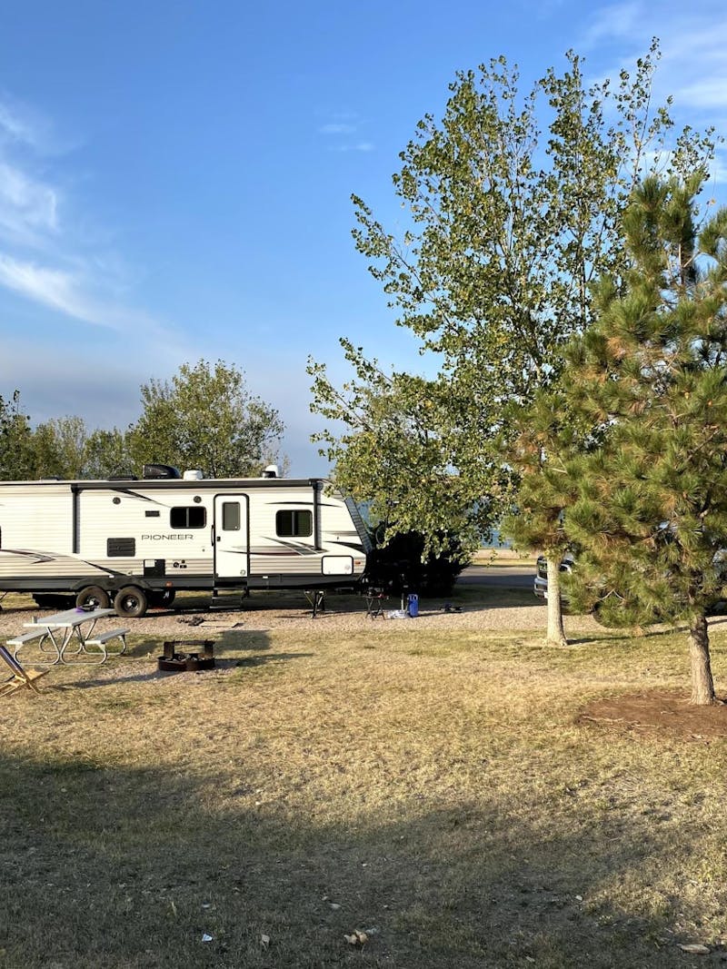 Abby Epperson's Heartland Pioneer parked at a campsite by a lake. 