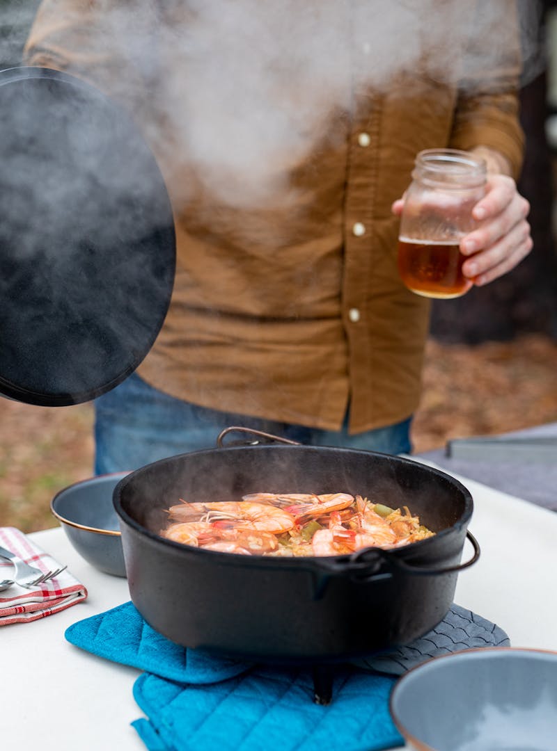 A steaming pot of jambalaya on a table.