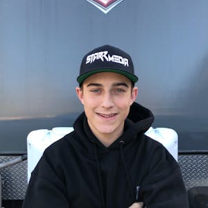A headshot of Taylor Walsh in front of his family's Jayco RV.