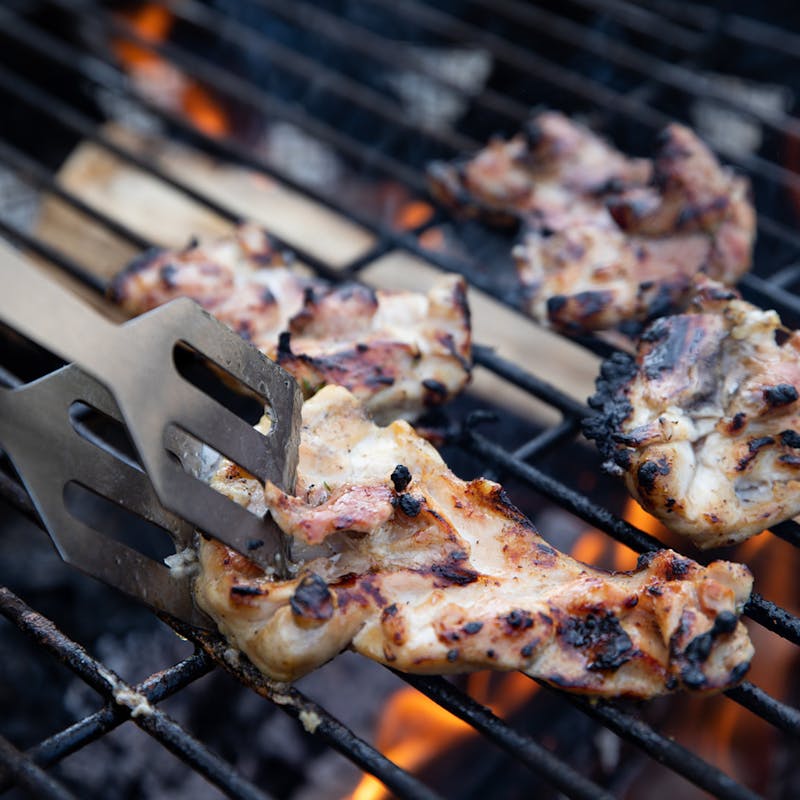 Chicken cooking on a grill.