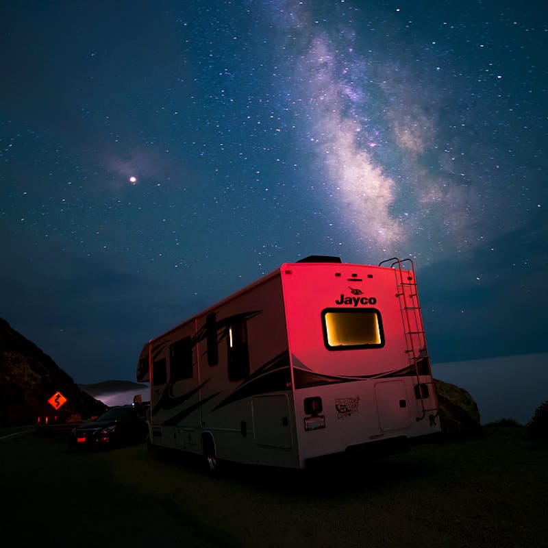 Sandra Peña's Jayco Class C RV parked under a starry sky in California.