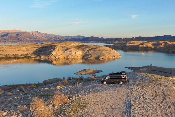 Gabe and Rocio Rivero's Thor Motor Coach Sequence at a boondocking spot near a lake and mountains.