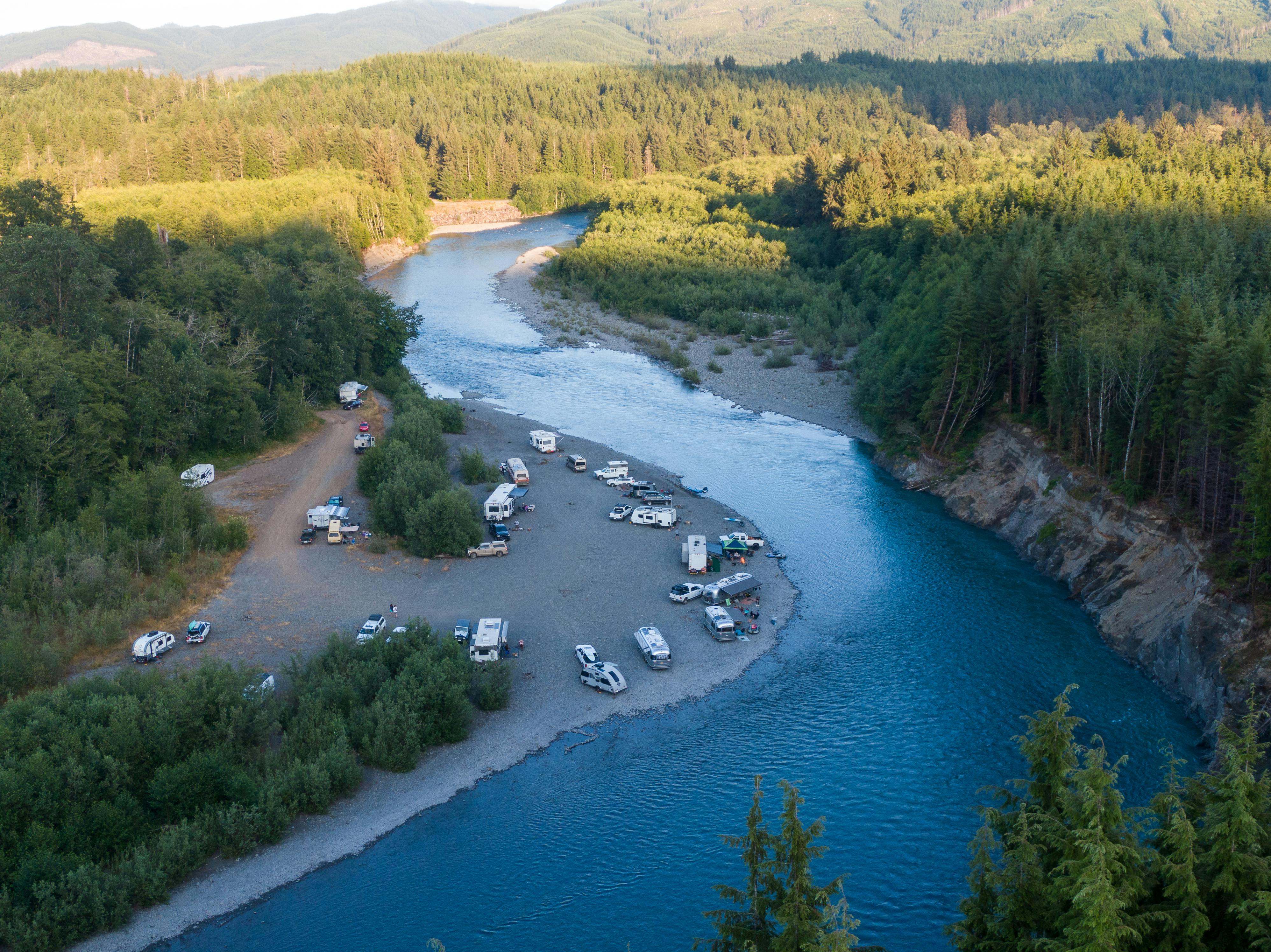 Karen Blue's Airstream parked by a river with other RVs