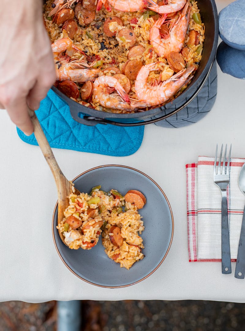 Serving up a bowl of jambalaya straight from the pot.