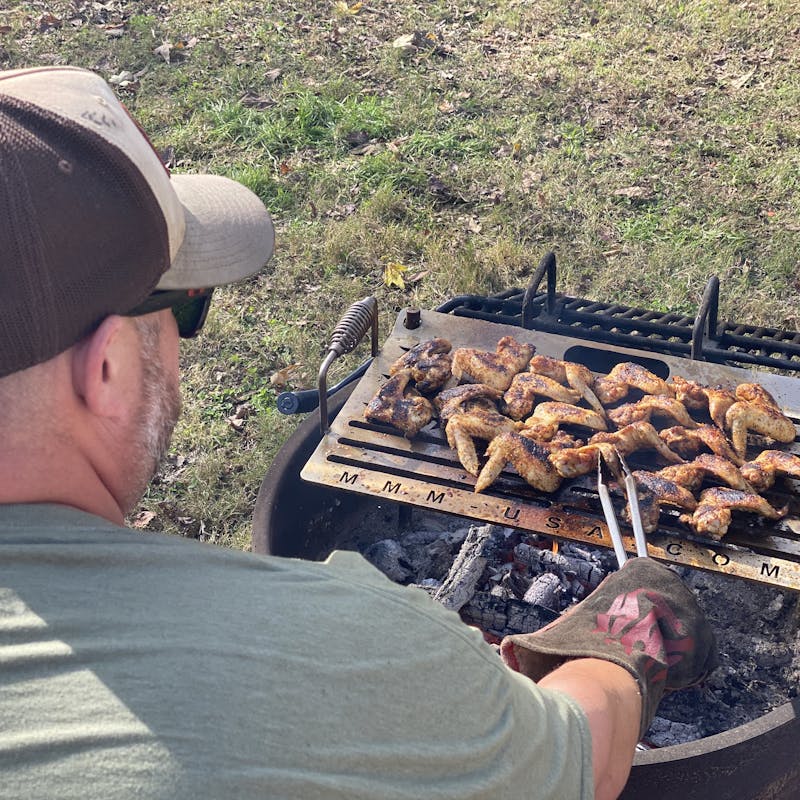 Abby Booth's husband grilling wings.