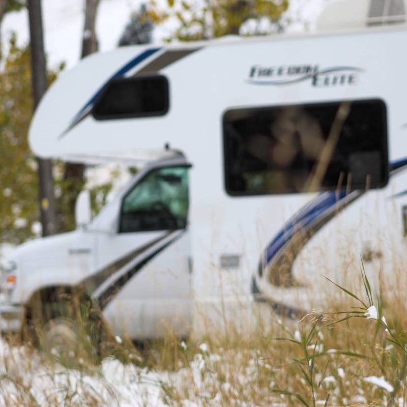 Class C motorhome in snow and snowy grass