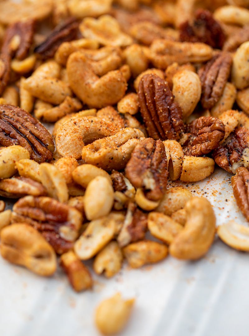 A close up shot of mixed nuts covered in Cajun spices.