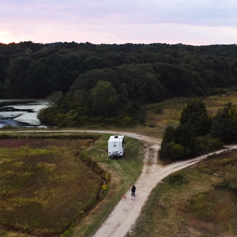 Sonya Lowery and Ray Young take their dog on a walk through the cranberry bog where their RV is parked.