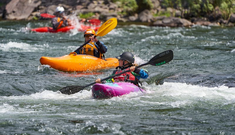 Two participants practice their new kayaking skills in the Blackfoot River.